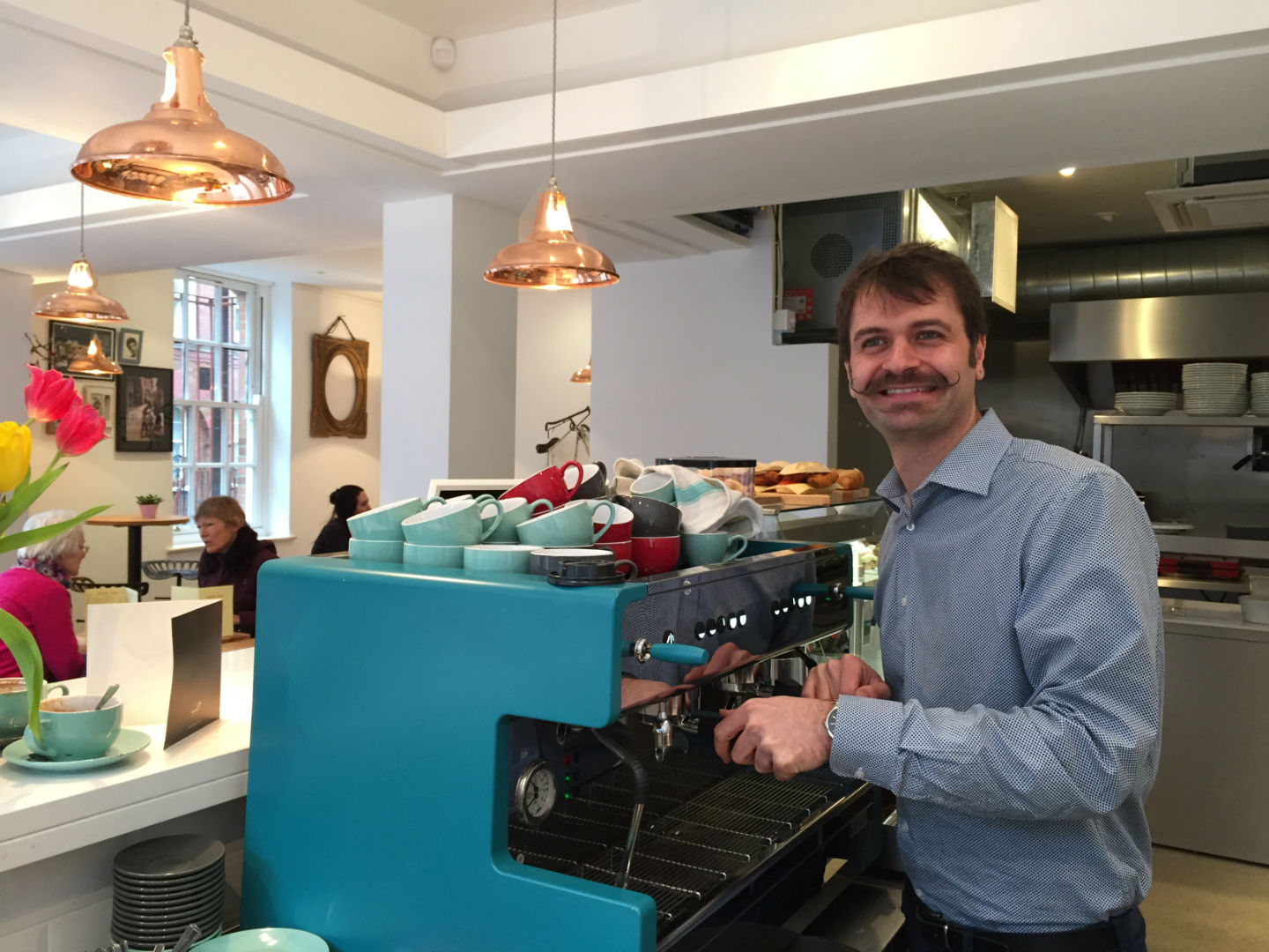 Owner Giuseppe cranks up the coffee machine. Photo: SE