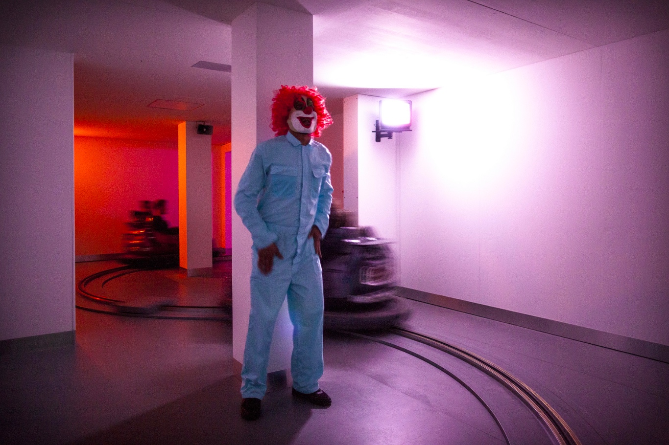 a clown stands in a pink room at Phobiarama