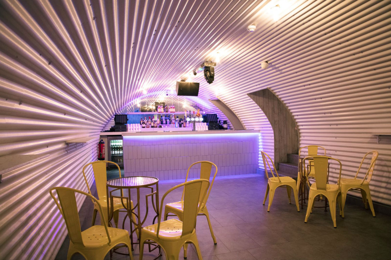 Inside She bar - chairs, a rounded tin roof,  